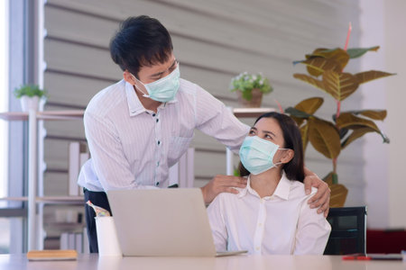 friend in company support each other in global crisis situationの写真素材