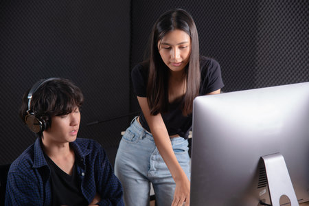 Video production editor team discussing together in front of monitorの写真素材