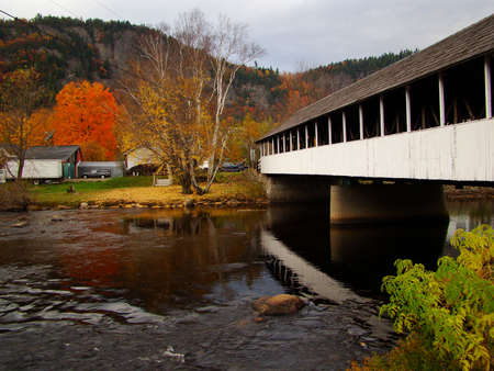 A covered bridge in New England during the fall