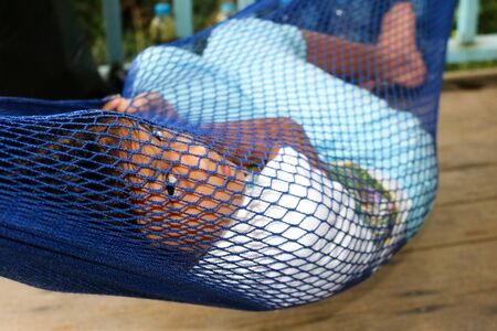 The girl lying in a hammock.