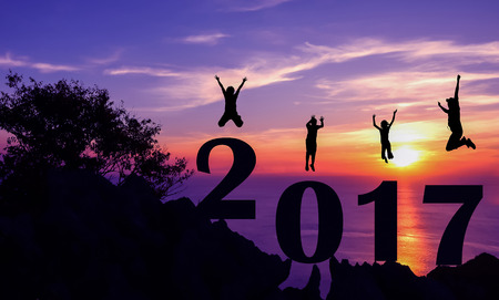 New year 2017 with family jumping on the mountain background.の写真素材