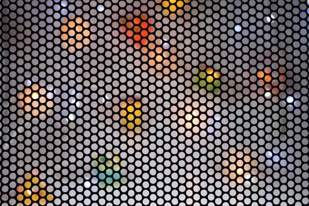 Different colors of light with steel grate background.の写真素材