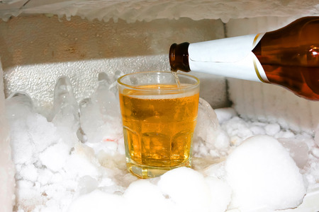 A glass of beer in the refrigerator.