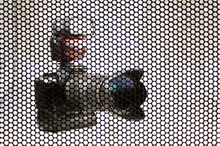 The Blurry Camera background.concept, shooting through the steel mesh to see the shape of the...