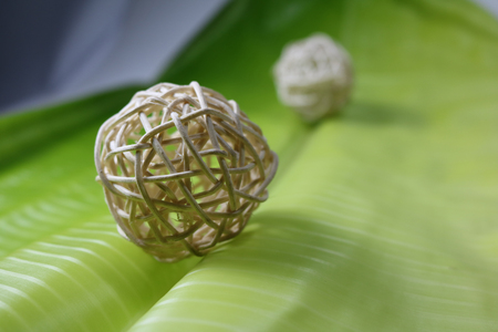 Ball weave with banana leaves backgroundの写真素材