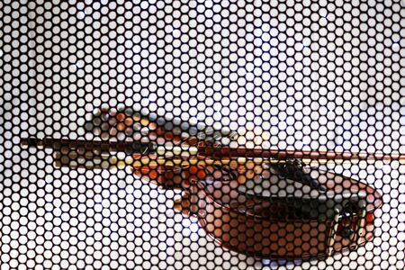 The Violin Background , concepts, shooting through the iron grating to see the shape of the violin, and blur the lens in some parts.の写真素材