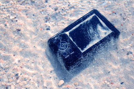 The Camera fall to the sea water near the beach.の写真素材