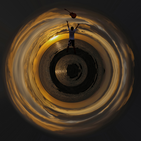 Men throwing the guitar with a red sky sunrise background, Circle design image.の写真素材