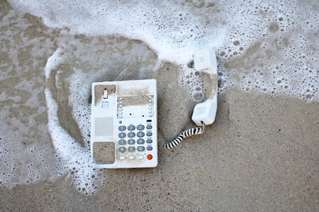 Telephone, Desk phone in the sand on the beachの写真素材