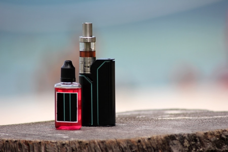 Electronic,Vapor cigarette on the beach.の写真素材