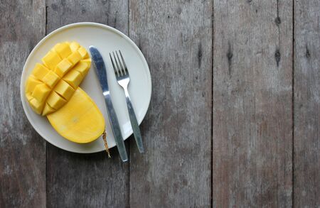 Yellow mango in the dishes on the table.の写真素材