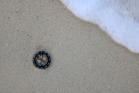 Compass in the sand on the beach.の写真素材