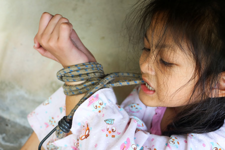 Asian human trafficking concept.Rope tied the hands of Thai girls.の写真素材
