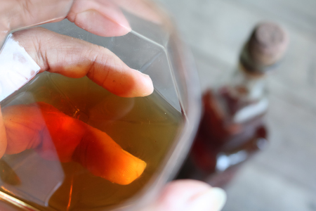 Local whiskey in a glass with bottle of herbal liquor.の写真素材