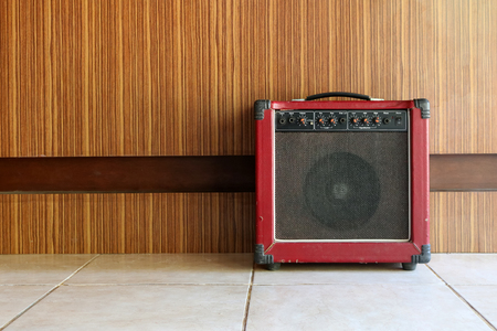 The old guitar amplifier with wooden walls.の写真素材