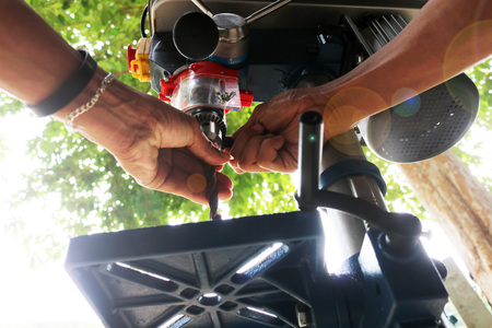 Drill presses machine with machinist.の写真素材