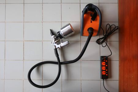 Electric sprayer with wooden wall.の写真素材