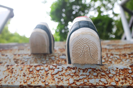 Shoes with a stair in the nature trail garden in Thailand.の写真素材