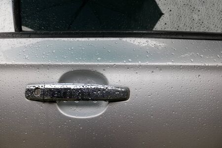 A car door is wet by the rain in Thailand.の写真素材