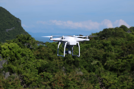 Drones camera flying in the sky with ocean and mountain views background.