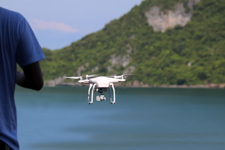 Drones camera flying in the sky with ocean views background.