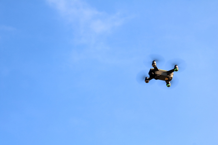 Drone camera or UAV flying in the blue sky backgroundの写真素材