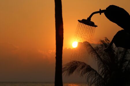 Outdoor beach showers with the red sky sunset backgroundの写真素材