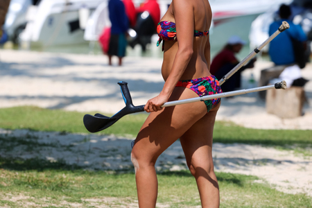 Injured tourist with crutch to supporting themself relax on the beach summer in Thailand.の写真素材