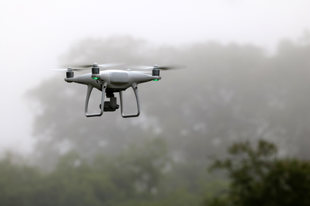 Drone Camera flying in the sky while the rain with mist, forests backgroundの写真素材