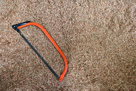 Yellow handsaws on the sawdust.の写真素材