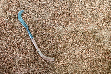 The big knife with long wooden handle on wooden sawdust.の写真素材