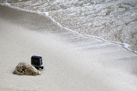 Small camera in the underwater housings set up on the beach by the sea.の写真素材