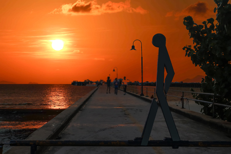 Walking sign and symbol on the bridge  with a sunset background.の写真素材