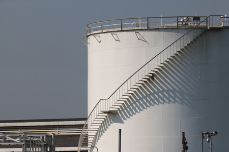 large white Industrial tanks for petrol and oil , Lights and shadows of the stairs.