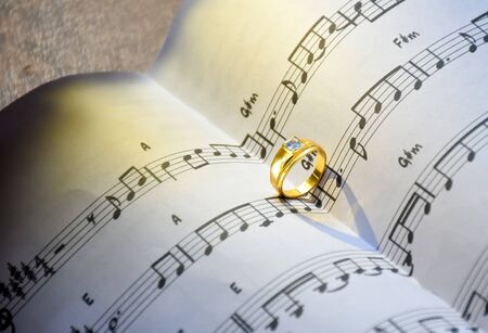 Symbol of love concept, Ring on the song books music notes.の写真素材