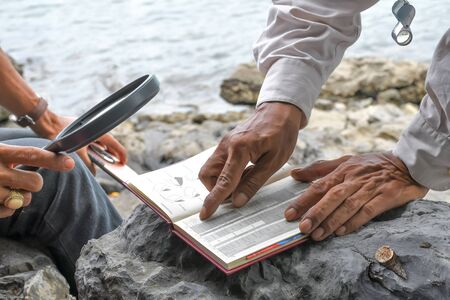 Archaeologists are using tools and equipment to explore fossils found in sedimentary rocks such as shale, sandstone or limestone.の写真素材