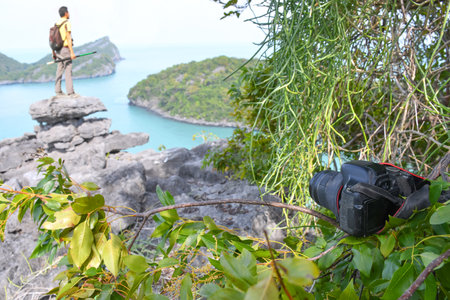 Photographers put the camera on a branch instead of a tripod on a viewpoint in Thailandの写真素材