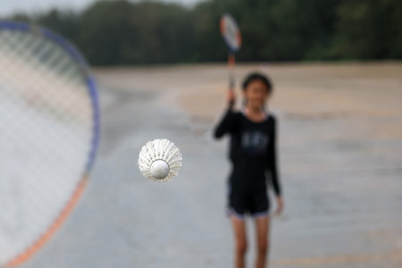 An Asian girl was playing badminton on the beach with her brother in Thailandの写真素材