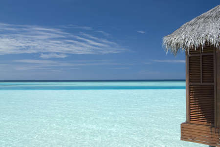 Maldivian overwater bungalow in a lagoon.の写真素材