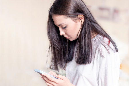 A young woman sends a text messageの写真素材