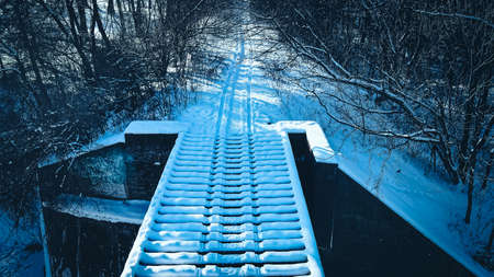 snowmobile tracks over old bridgeの写真素材