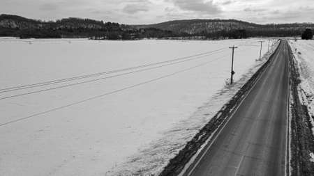 Snow covers the land with snow covered agricultural fields