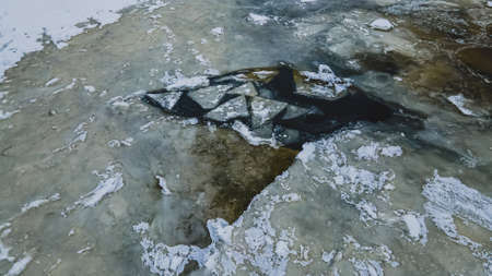 A broken surface on a cold lakeの写真素材