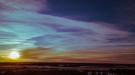 A majestic winter sunset with clouds like wings.