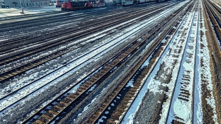 Empty railyard in winter that has snow on the ground