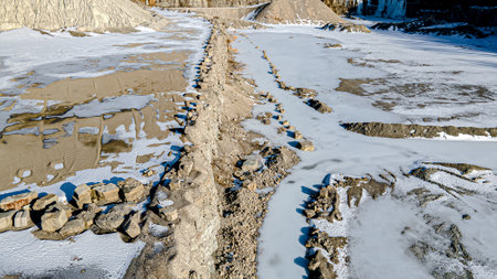 Winter snow covered open pit rock quarry in wisconsin.の写真素材
