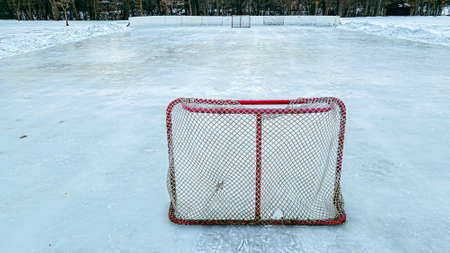 A bright red hockey net on a outdoors ice rinkの写真素材