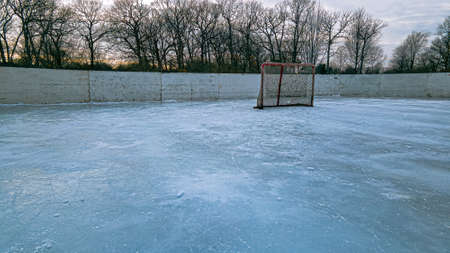 A bright red hockey net on a outdoors ice rinkの写真素材