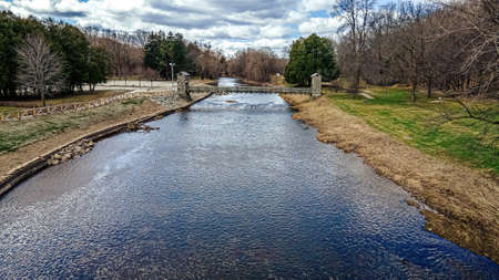 The snow has melted and the water is no longer frozen. The water flows down the river with the...