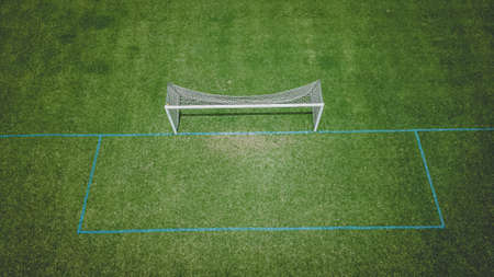 Fresh green grass is growing on the soccer fields at a local parkの写真素材